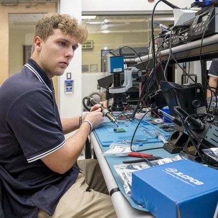 Brice Carlson, COE’25 work with Professor Richard Martin and Mark Manniso on a dental prototype made with a 3-D Printer with built in illumination to aid hygienists and dentists in dental care. 