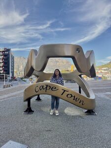Aratrika Ghosh stands inside a sculpture that says Cape Town in South Africa