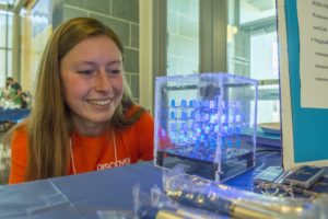 Student looks at a display at the the E-Week Carnival