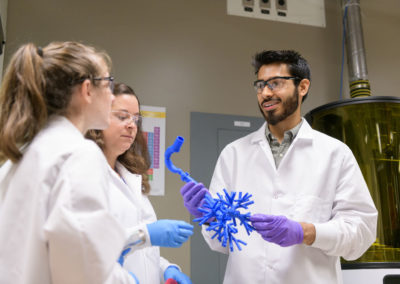 Azeem Sharief with faculty mentor Cathy Fromen. He is holding a 3d printed lung.
