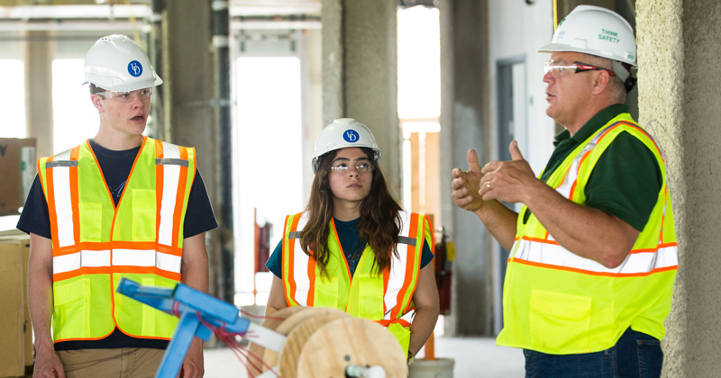 UD students Nick Sabatini and Alexa Johnson, and Craig Sams, a senior project project manager at Bancroft Construction, are pictured touring the STAR tower when it was under construction earlier in 2018.
