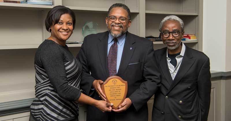 Michael Vaughan (middle), associate dean of academic affairs for the College of Engineering is the recipient of the 2018 John Warren Award. He was presented the award by Darcell Griffith, director of compensation and benefits (left) and nominated by Babatunde Ogunnaike, William L. Friend Chair of Chemical Engineering (right).