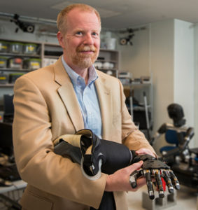 Mike McLoughlin holds the prototype.