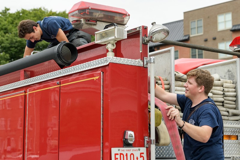  Matthew Heebner (left) and Connor Sproat check equipment on the truck during some downtime at the station. 