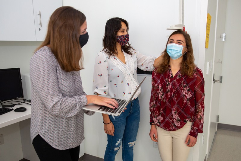 Shannon Robson (left), an associate professor, practices interventions with research assistants Adriana Verdezoto Alvarado (center) and Bailey Davin in the Energy Balance and Nutrition Lab.