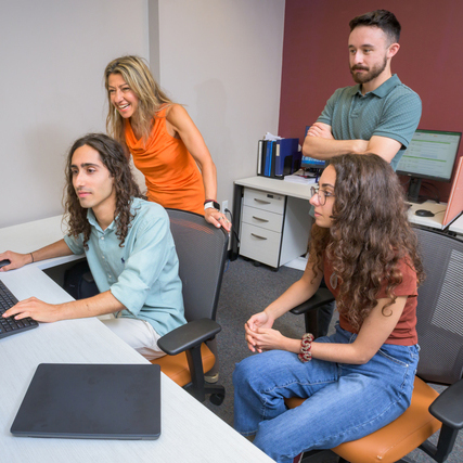 Marianthi Ierapetritou, the Bob and Jane Gore Centennial Chair of Chemical & Biomolecular Engineering (in orange) works with graduate students on a project in a computer lab.