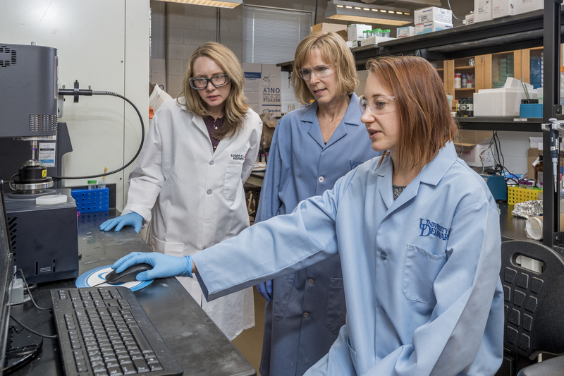 Drs. Kristi Kiick (blonde hair) and April Kloxin (dark blonde hair) along with graduate student Paige LeValley (red hair) worked together getting a patent for Photo Cleavable Linkages for delivering targeted medication for melanoma.
